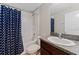 Bathroom with shower/tub combo and a navy blue shower curtain at 10005 Caraway Spice Ave, Riverview, FL 33578