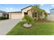 Tan house with a two-car garage and palm trees at 10005 Caraway Spice Ave, Riverview, FL 33578