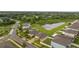 Aerial view of a residential neighborhood with houses, pond, and lush green areas at 10005 Caraway Spice Ave, Riverview, FL 33578