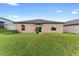 Large backyard with grassy area and home view at 10005 Caraway Spice Ave, Riverview, FL 33578