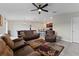 Living room with brown leather furniture and a view into the kitchen and dining area at 10005 Caraway Spice Ave, Riverview, FL 33578