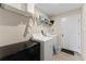 Bright laundry room, washer, dryer, shelving at 10005 Caraway Spice Ave, Riverview, FL 33578