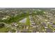 Aerial view showing a home situated in a quiet residential neighborhood near a pond at 10005 Caraway Spice Ave, Riverview, FL 33578