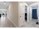 Bright hallway with tile floors, leading to bedrooms and bathroom at 10005 Caraway Spice Ave, Riverview, FL 33578