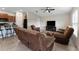 Living room with brown leather furniture and a view into the kitchen at 10005 Caraway Spice Ave, Riverview, FL 33578