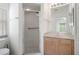 Bathroom featuring a walk-in shower and vanity with abundant light at 11230 Heathrow Ave, Spring Hill, FL 34609