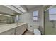 Well-lit bathroom with a walk-in shower, updated vanity, and modern fixtures at 2607 Royal Ridge Dr, Spring Hill, FL 34606