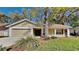 Inviting single-story home featuring a well-maintained yard and an attached two-car garage at 2607 Royal Ridge Dr, Spring Hill, FL 34606