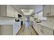Modern kitchen featuring white cabinets, quartz countertops, and stainless steel appliances at 2607 Royal Ridge Dr, Spring Hill, FL 34606