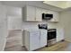 Well-appointed kitchen with stainless steel appliances, white cabinets, and modern finishes at 2607 Royal Ridge Dr, Spring Hill, FL 34606