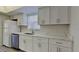 Updated kitchen featuring stainless steel appliances, white cabinets, and solid surface countertops at 2607 Royal Ridge Dr, Spring Hill, FL 34606