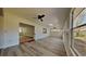 Bright living room with windows, vinyl floors, and a ceiling fan, offering ample natural light at 2607 Royal Ridge Dr, Spring Hill, FL 34606