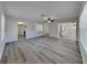 Open-concept living room with wood-look flooring, connecting seamlessly to the kitchen at 2607 Royal Ridge Dr, Spring Hill, FL 34606