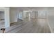 Bright and open living space featuring wood-look flooring, fresh paint, and plenty of natural light at 2607 Royal Ridge Dr, Spring Hill, FL 34606