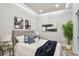 Cozy bedroom featuring tray ceilings, neutral walls, and decorative throw pillows and blankets at 912 Channelside Dr # 2316, Tampa, FL 33602