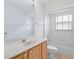Clean bathroom with tub, vanity, and tiled walls at 11230 Heathrow Ave, Spring Hill, FL 34609