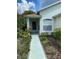 Well-maintained house exterior featuring a walkway and lush landscaping at 11230 Heathrow Ave, Spring Hill, FL 34609