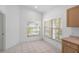 Bright kitchen nook with tile floor and window overlooking backyard at 11230 Heathrow Ave, Spring Hill, FL 34609