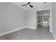 Spacious bedroom with wood-look floors and access to another room at 638 Limona Woods Dr, Brandon, FL 33510