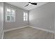 Bright bedroom with wood-look floors, ceiling fan, and plantation shutters at 638 Limona Woods Dr, Brandon, FL 33510