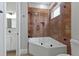 Spa-like bathroom with corner soaking tub and marble tile at 638 Limona Woods Dr, Brandon, FL 33510