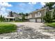 Home with a circular driveway and three-car garage at 638 Limona Woods Dr, Brandon, FL 33510