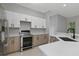 Modern kitchen with sleek cabinetry, quartz countertops, and stainless steel appliances at 638 Limona Woods Dr, Brandon, FL 33510