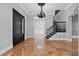 Grand entryway boasts marble floors, a statement chandelier, and a black front door at 638 Limona Woods Dr, Brandon, FL 33510
