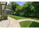 Landscaped backyard with a stone pathway leading to a screened pool area at 638 Limona Woods Dr, Brandon, FL 33510