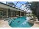 Inviting, freeform pool and spa with a screened enclosure at 638 Limona Woods Dr, Brandon, FL 33510