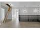 Upstairs hallway with attic access, wood-look floors and two rooms at 638 Limona Woods Dr, Brandon, FL 33510