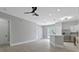 Bright and airy living room with wood-look floors and access to kitchen at 638 Limona Woods Dr, Brandon, FL 33510