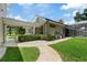 A stone pathway meanders through the grassy backyard toward the pool at 638 Limona Woods Dr, Brandon, FL 33510