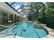 Inviting, freeform pool and spa with a screened enclosure at 638 Limona Woods Dr, Brandon, FL 33510