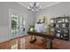 Bright home office with built-in shelving, large windows, and a workspace at 638 Limona Woods Dr, Brandon, FL 33510