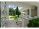 Inviting front porch with white railings overlooking the manicured lawn at 638 Limona Woods Dr, Brandon, FL 33510