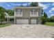 Two-car garage with a star-shaped driveway and charming upper-level balconies at 638 Limona Woods Dr, Brandon, FL 33510