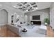 Open living area with coffered ceiling, large TV, and ample seating at 638 Limona Woods Dr, Brandon, FL 33510