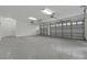 Bright and spacious garage featuring epoxy flooring and overhead storage at 638 Limona Woods Dr, Brandon, FL 33510