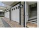 Exterior view of a two-car garage with stairs leading to an upper level at 638 Limona Woods Dr, Brandon, FL 33510