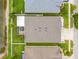 Aerial view of the home showing the roof, screened-in lanai, and the surrounding landscaping and neighborhood pond at 6843 Boulder Run Loop, Wesley Chapel, FL 33545