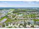 Panoramic aerial view showcasing community with mature trees, lush landscaping, and scenic lakes at 6843 Boulder Run Loop, Wesley Chapel, FL 33545