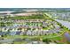 Overhead shot of a neighborhood featuring well-maintained homes and picturesque ponds with community green space at 6843 Boulder Run Loop, Wesley Chapel, FL 33545