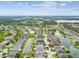 An aerial view of a neighborhood showcasing numerous homes, several ponds, and lush greenery, creating a serene community at 6843 Boulder Run Loop, Wesley Chapel, FL 33545