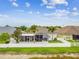 Beautiful backyard featuring a screened lanai and lush green grass, perfect for entertaining at 6843 Boulder Run Loop, Wesley Chapel, FL 33545