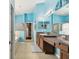 Bright bathroom with blue walls, dual sinks, and a walk-in closet at 6843 Boulder Run Loop, Wesley Chapel, FL 33545