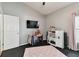 A bedroom featuring a play kitchen, TV and a baby playpen, set against neutral walls at 6843 Boulder Run Loop, Wesley Chapel, FL 33545