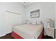 Well-lit bedroom features a comfortable bed, wood floors, and closet at 6843 Boulder Run Loop, Wesley Chapel, FL 33545