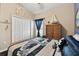 Decorated bedroom featuring a navy-themed bedspread, white closet doors and nautical decorations at 6843 Boulder Run Loop, Wesley Chapel, FL 33545