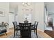 Bright dining area with a round table, dark wood chairs, and sheer curtains allowing for natural light at 6843 Boulder Run Loop, Wesley Chapel, FL 33545